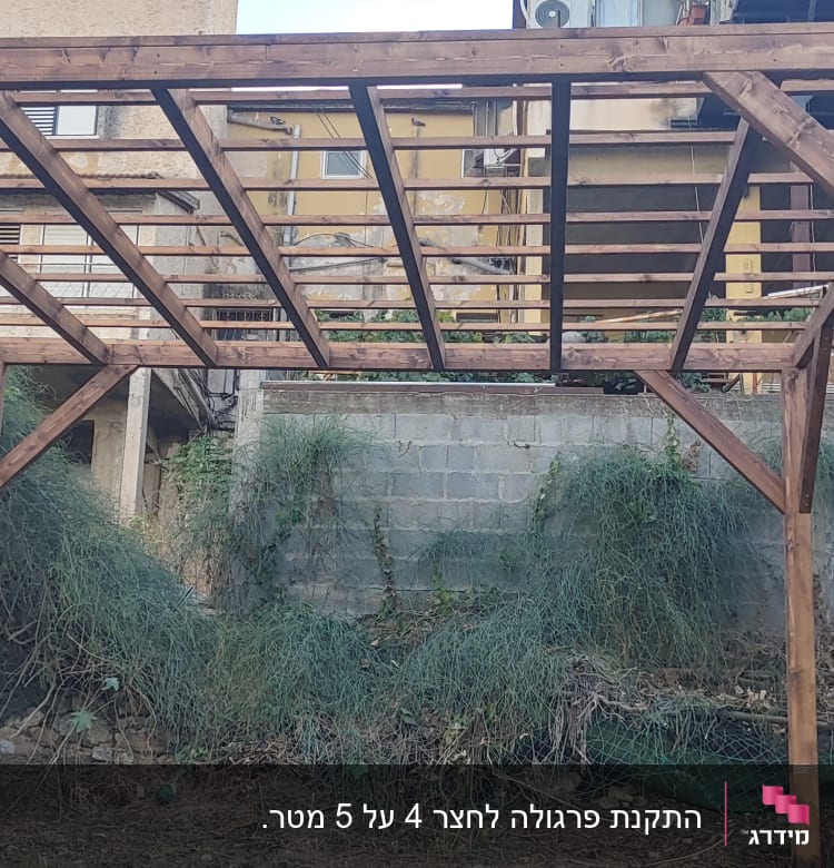 פרגולה מעץ בגינה עם קורות עץ חומות